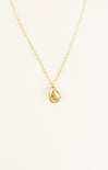 Gold necklace with a teardrop pendant on a white background