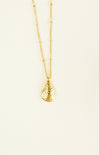 Gold necklace with a teardrop pendant on a beige background