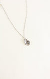 Teardrop-shaped pendant necklace on a white background
