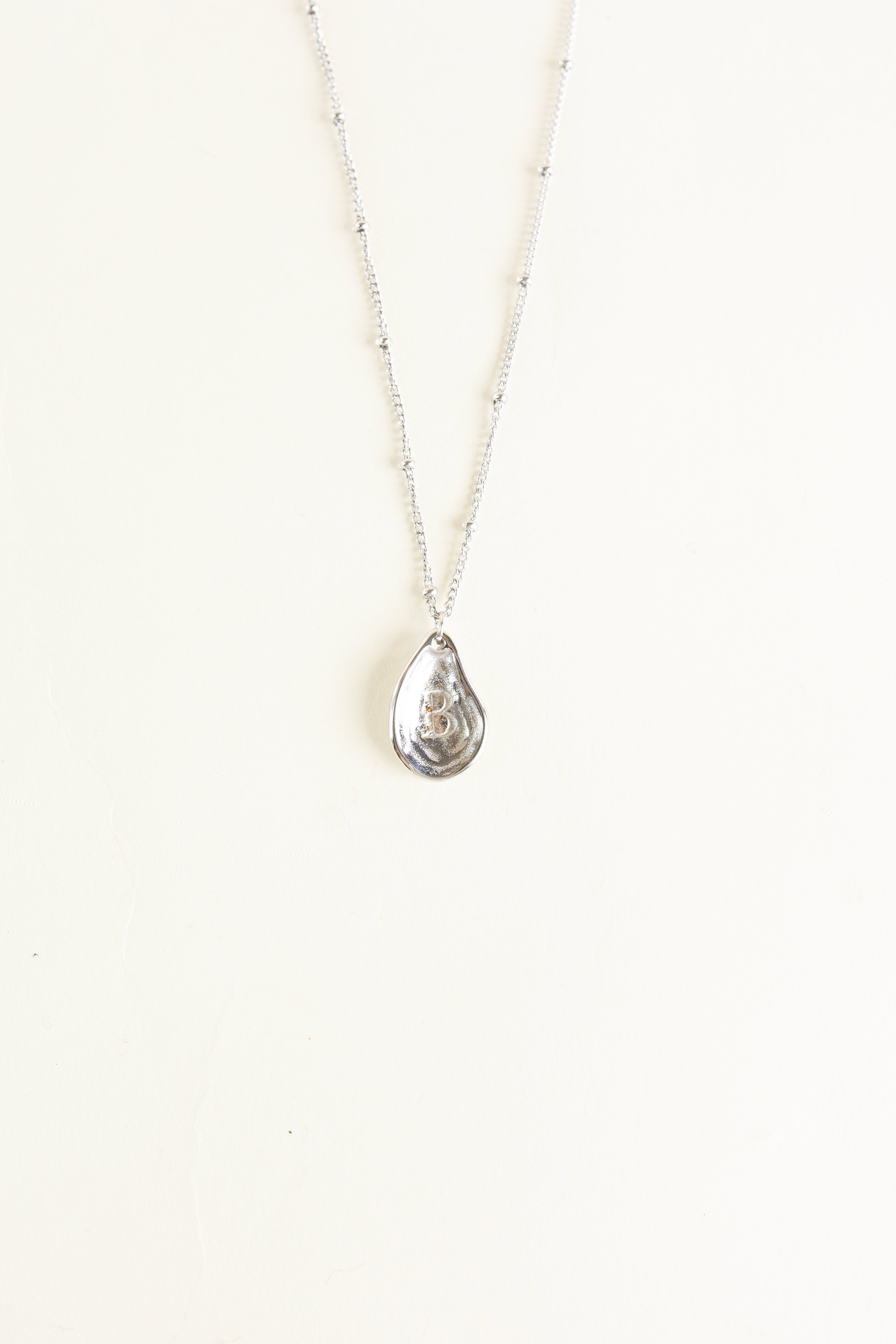 Necklace with a teardrop-shaped pendant on a white background