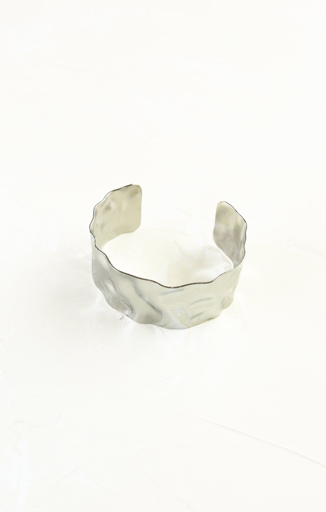 Silver cuff bracelet on a white background