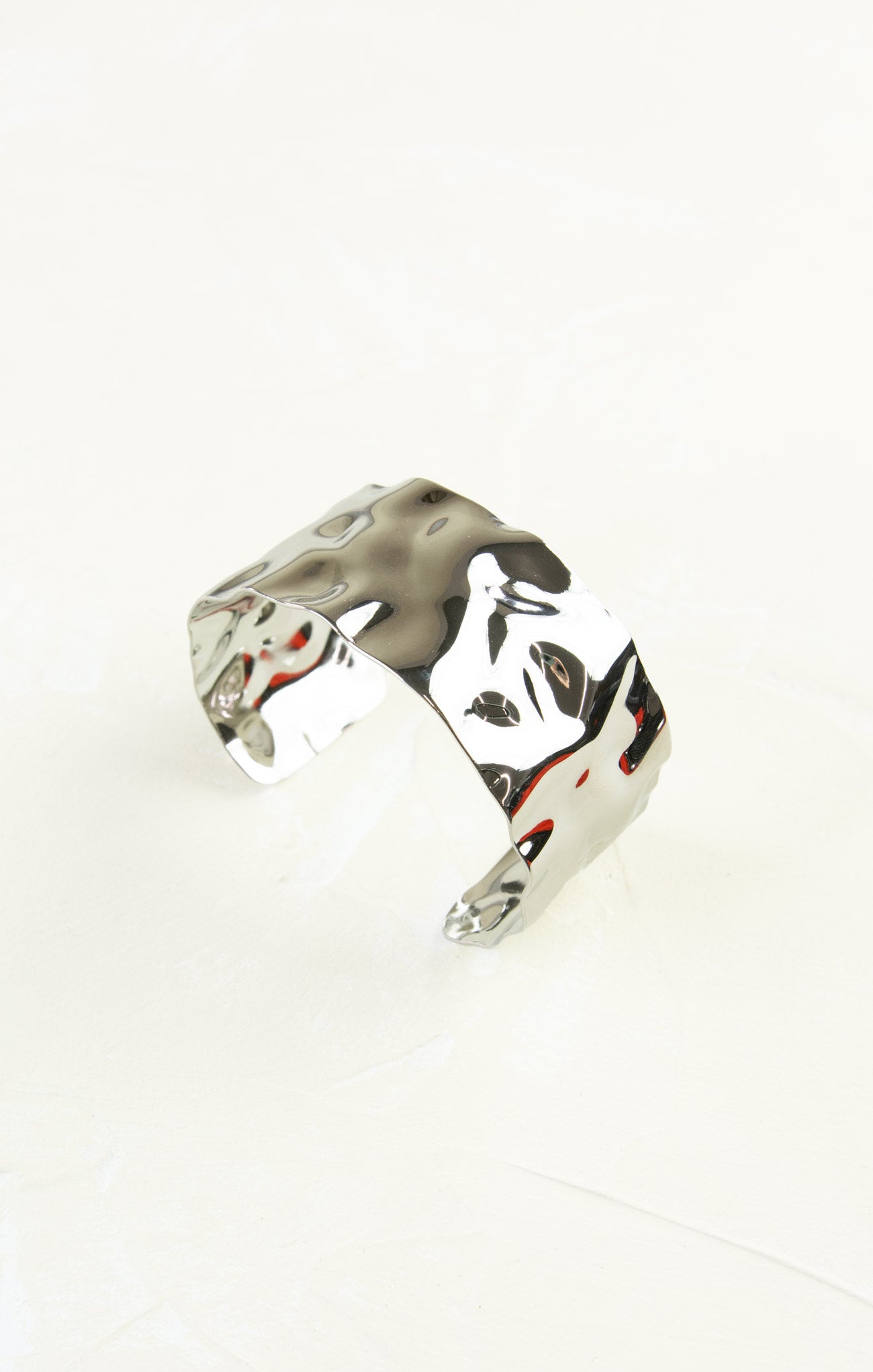 Silver ring with a unique design on a white background