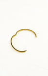 Gold hoop earring on a white background
