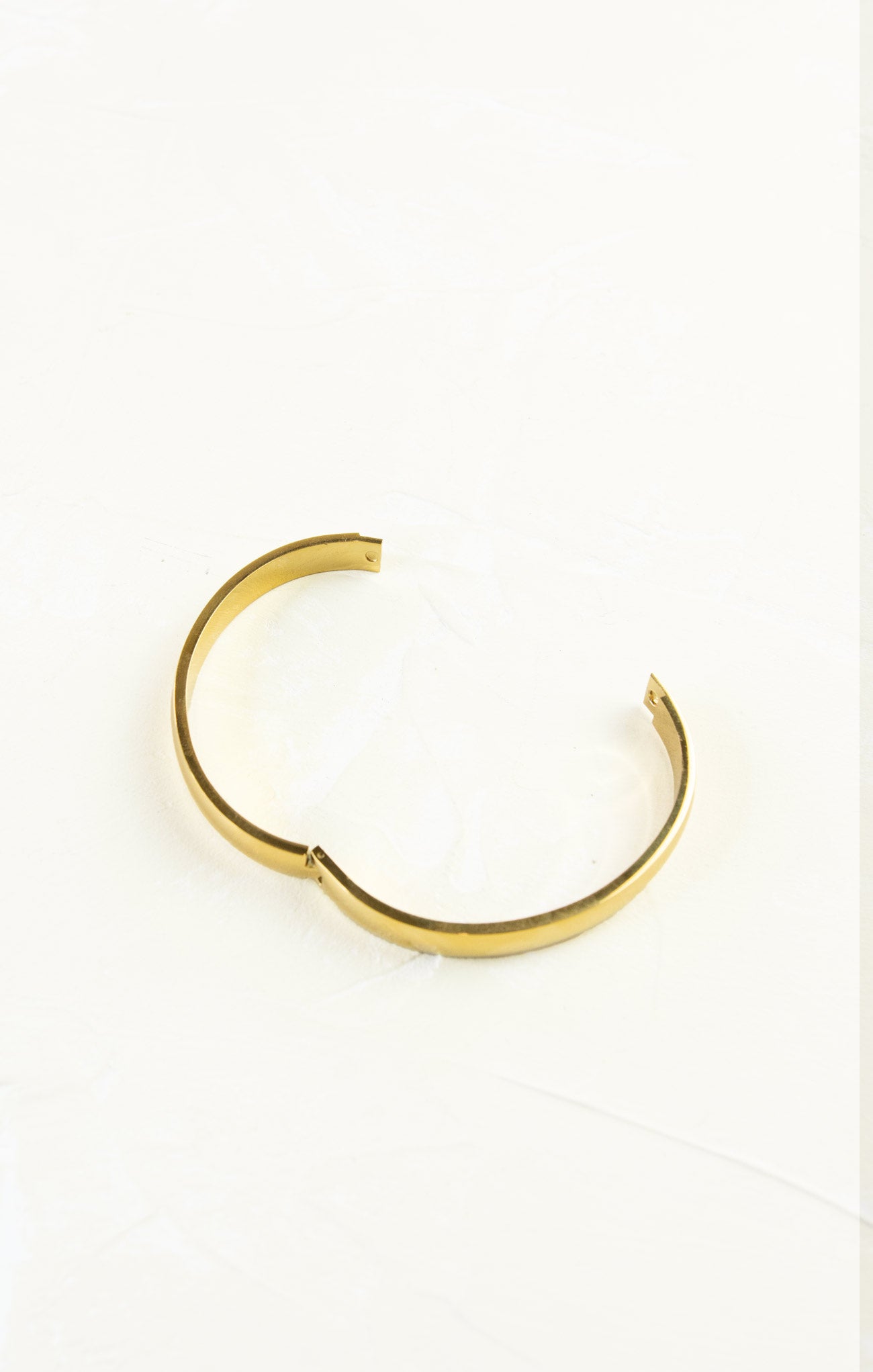Gold bracelet on a white background