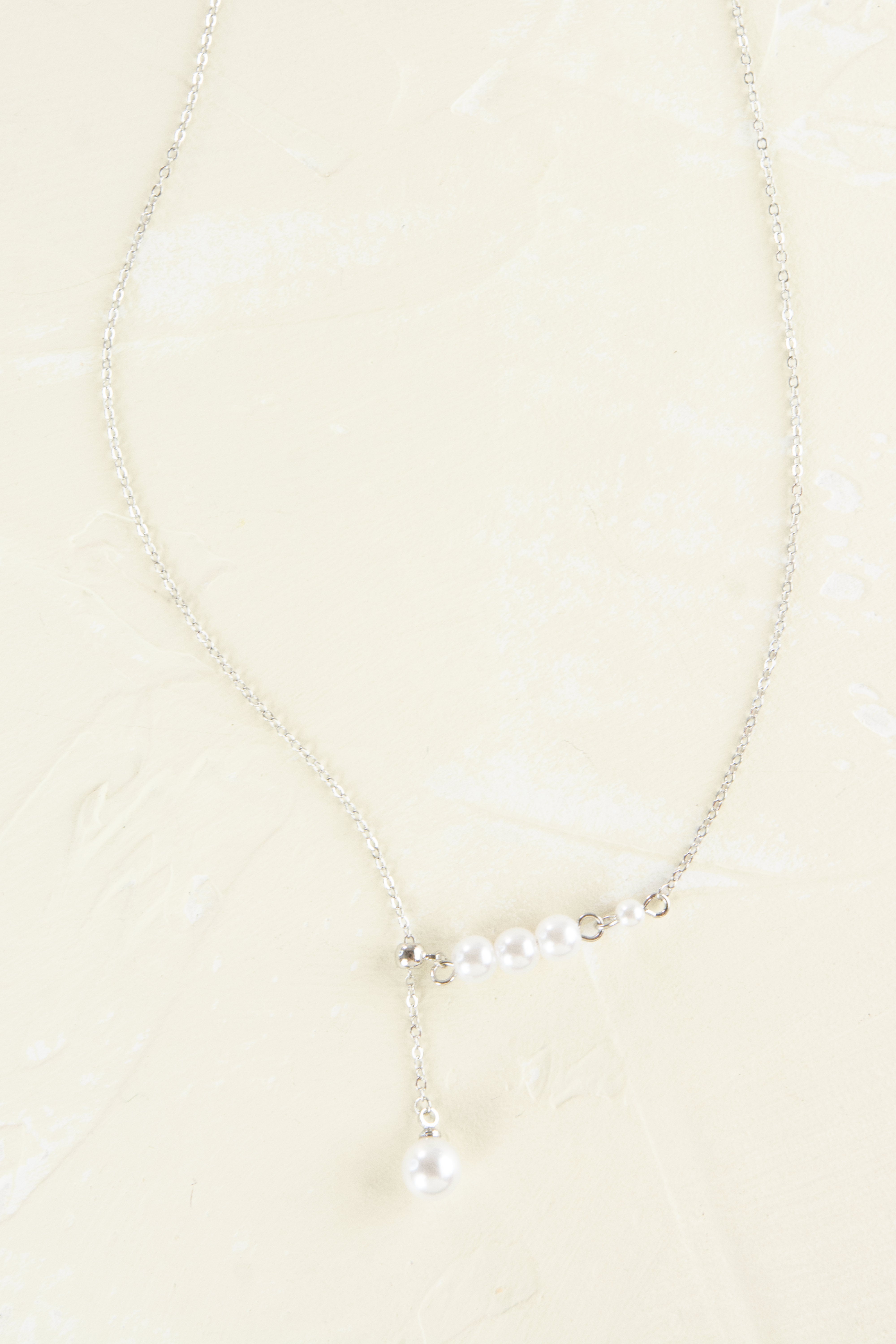 Pearl necklace on a beige background