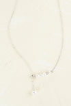 Pearl necklace on a beige background