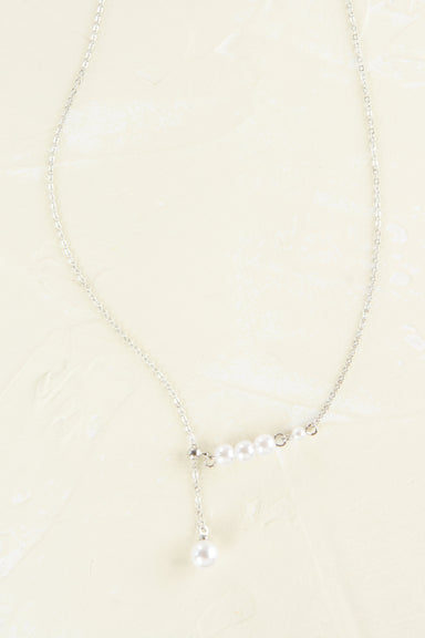 Pearl necklace on a beige background