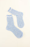 Pair of light blue socks on a beige background