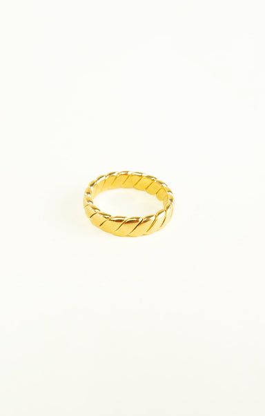 Gold ring with a textured design on a white background
