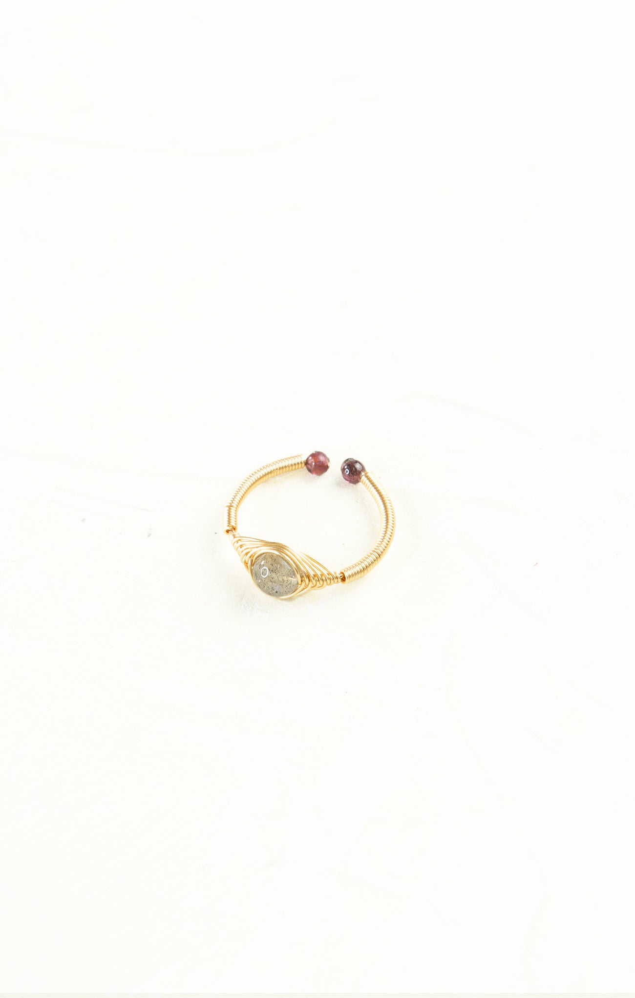Gold bracelet with gemstones on a white background