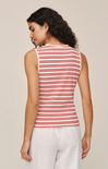 Woman wearing a red and white striped sleeveless top against a beige background