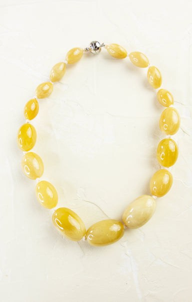 Necklace with yellow beads on a white background