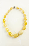 Necklace with yellow beads on a white background