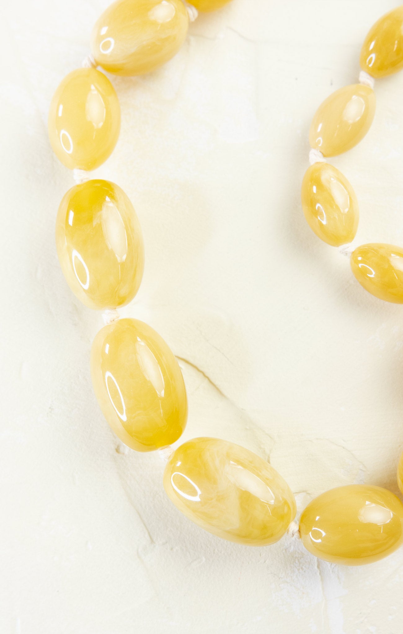 Necklace with yellow beads on a white background