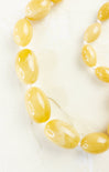 Necklace with yellow beads on a white background