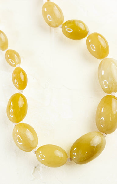 Necklace with yellow beads on a white background