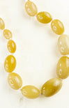 Necklace with yellow beads on a white background