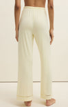Light-colored pants worn by a person on a plain background