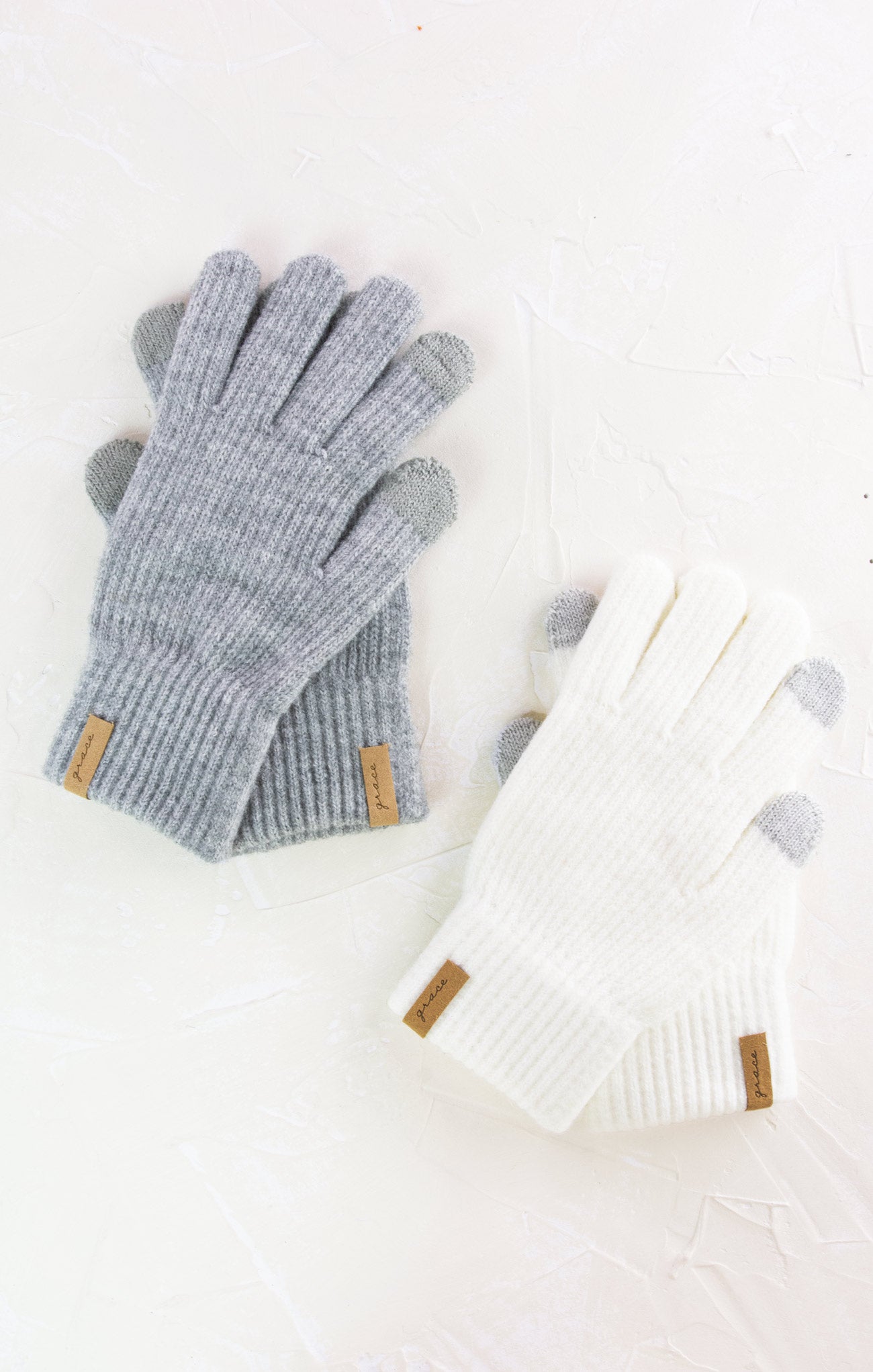Pair of gray gloves with a textured pattern on a white background