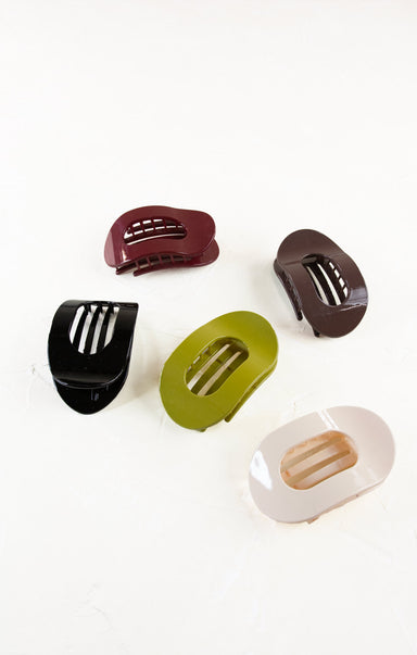 Set of five colorful hair clips on a white background