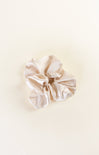 Beige scrunchie on a light beige background