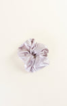 Silky scrunchie on a light beige background