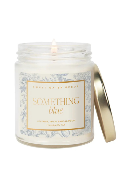 Candle in a jar labeled 'Something Blue' with a decorative label on a white background