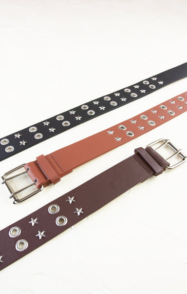 Three belts with star and button details on a white background