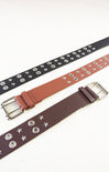 Three belts with star and button details on a white background