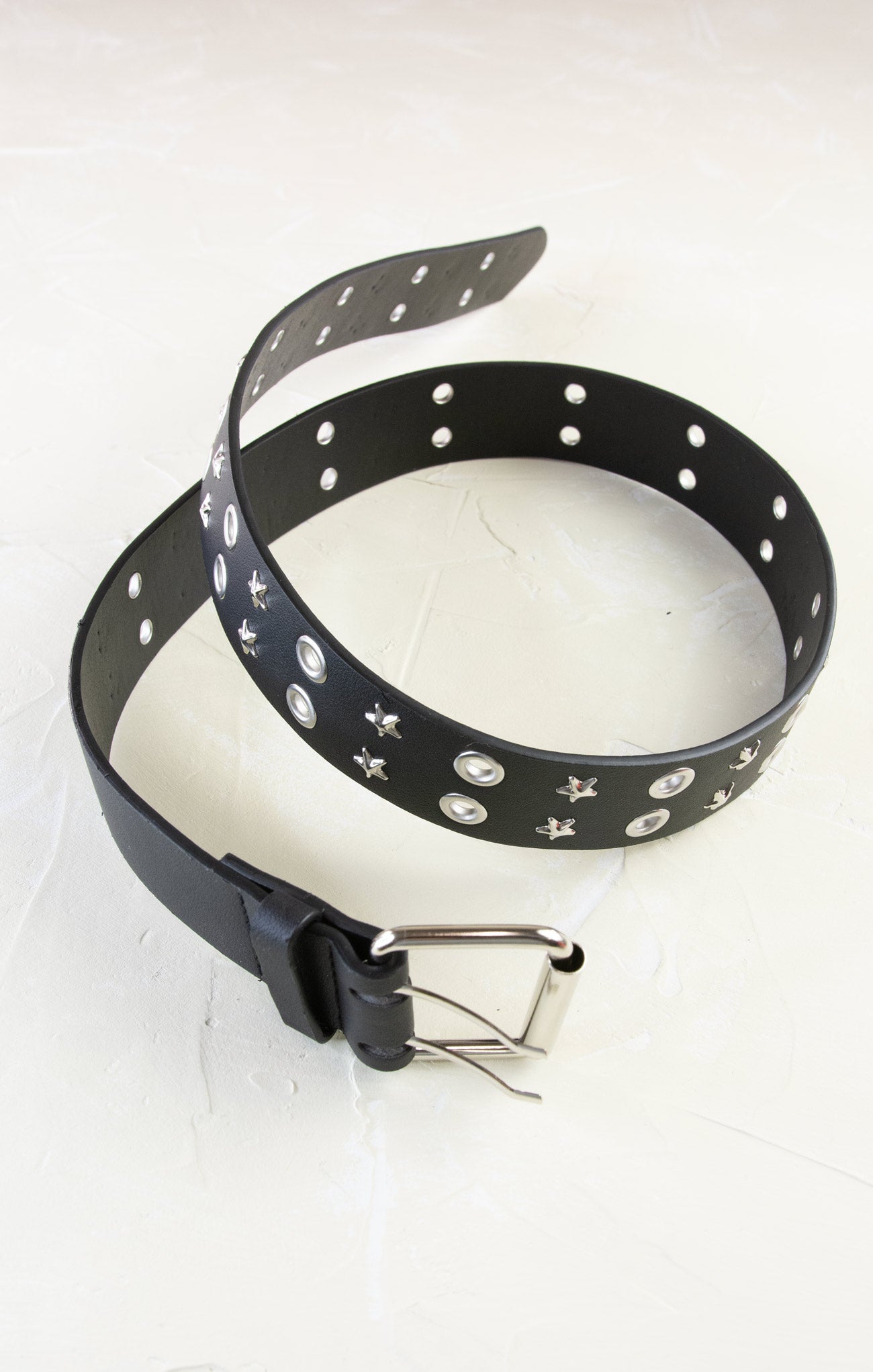 Black belt with silver studs on a white background