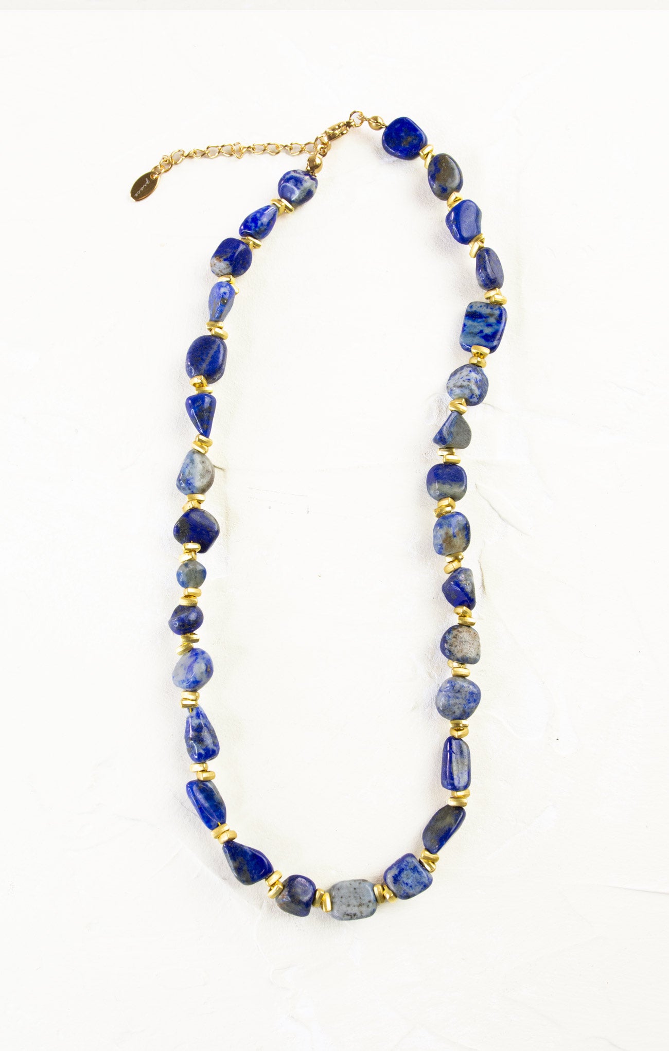 Necklace with blue beads and gold accents on a white background