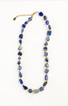 Necklace with blue beads and gold accents on a white background