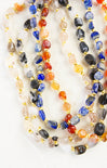 Multicolored beaded necklaces on a white background