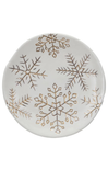 Round ceramic plate with gold snowflake patterns on a white background