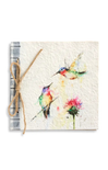 Notebook with watercolor design of hummingbirds and flowers, tied with twine on a white background