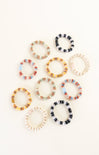 Set of colorful beaded hair ties on a white background
