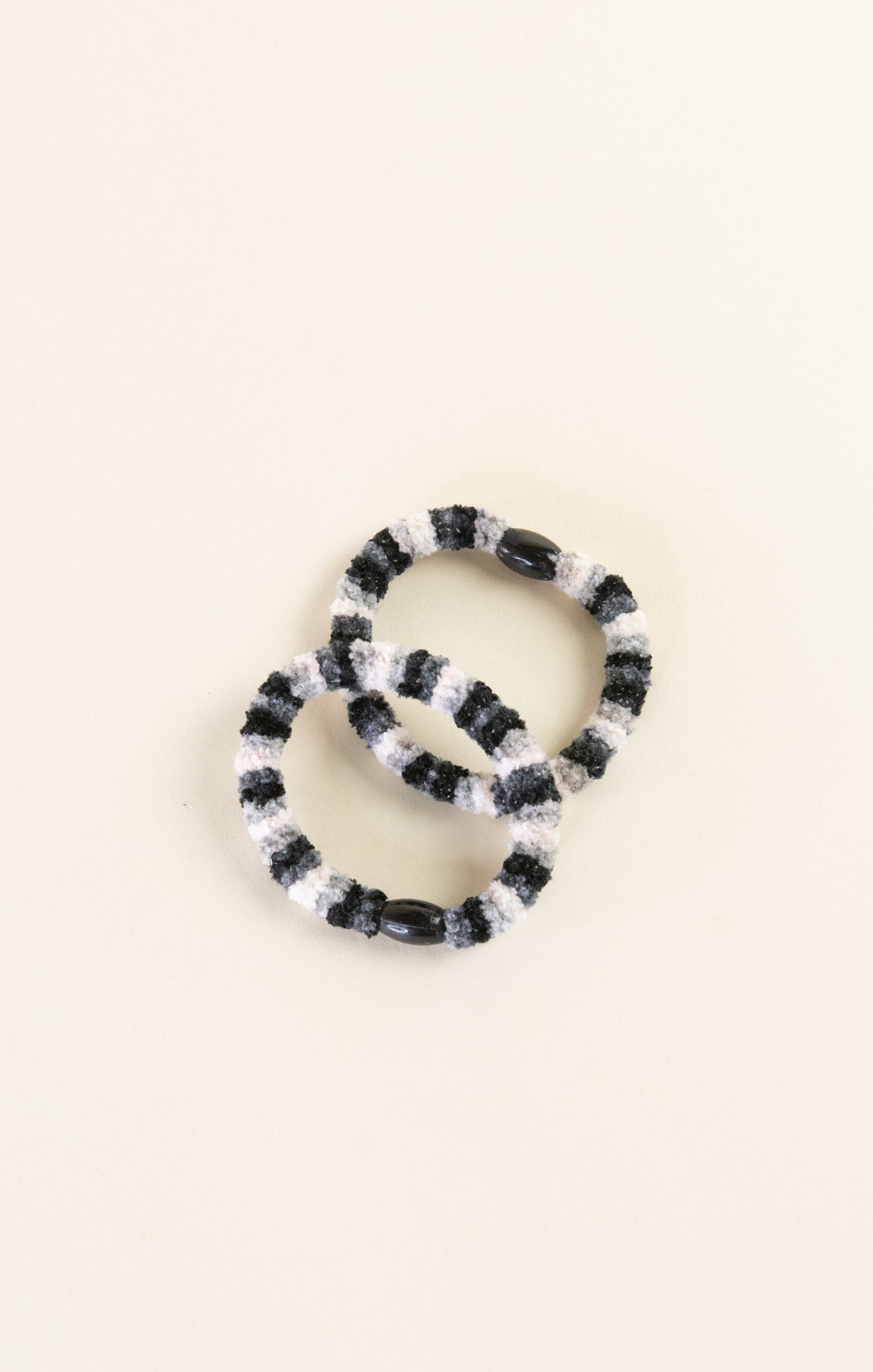 Black and white beaded bracelet on a beige background