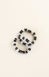 Black and white beaded bracelet on a beige background