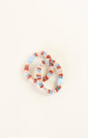 Set of colorful beaded bracelets on a light beige background