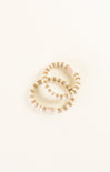 Set of pearl bracelets on a light beige background