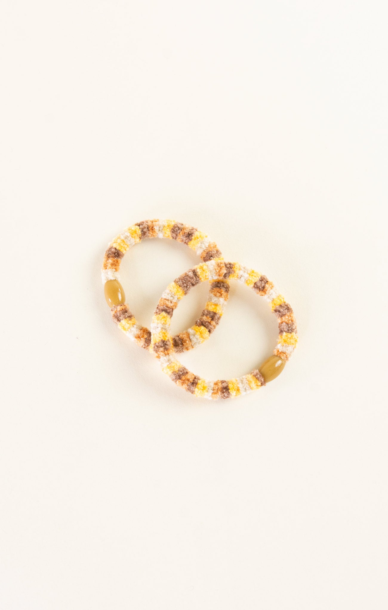 Two beaded bracelets on a white background