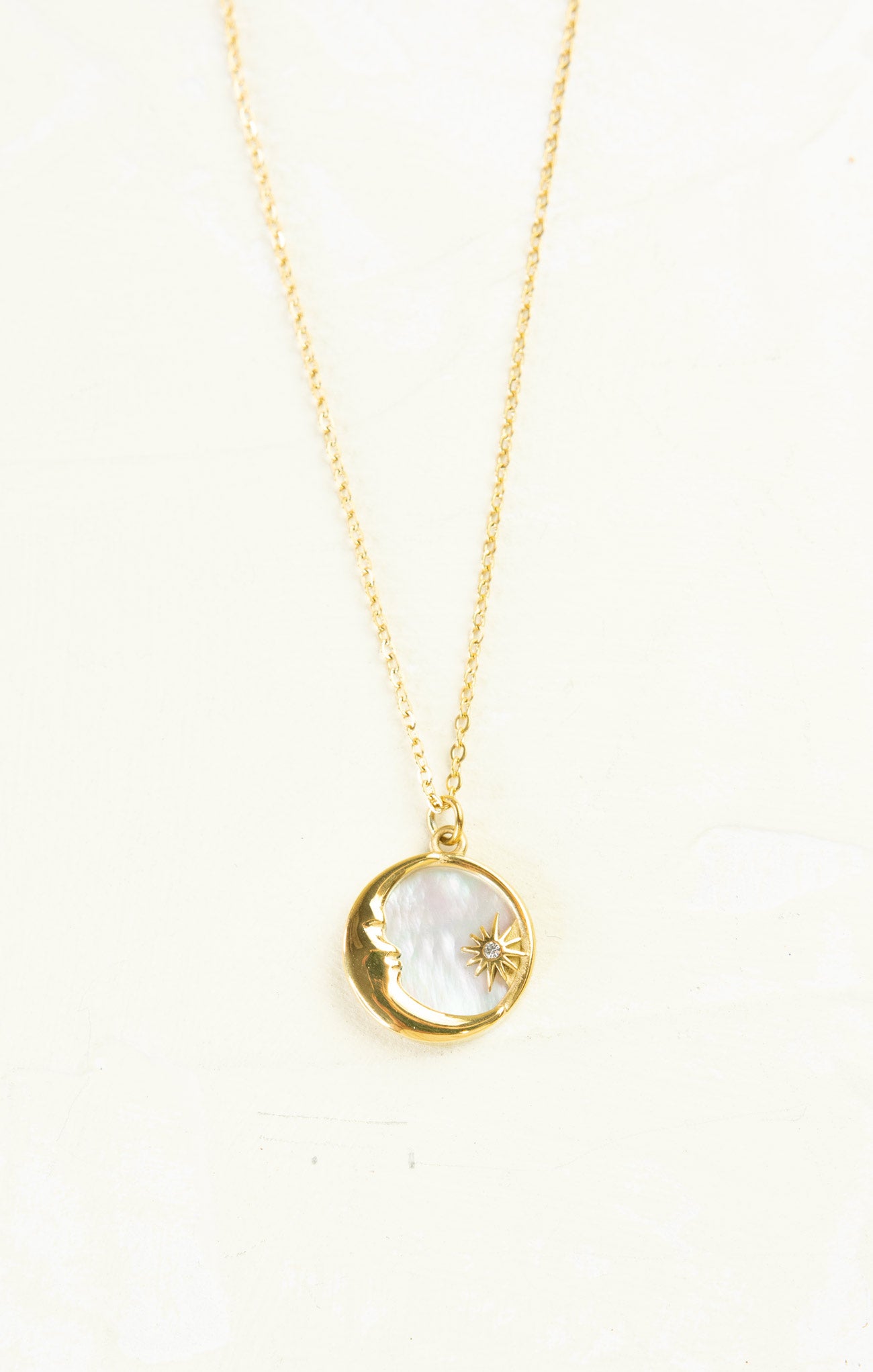 Gold chain with sun and moon pendant