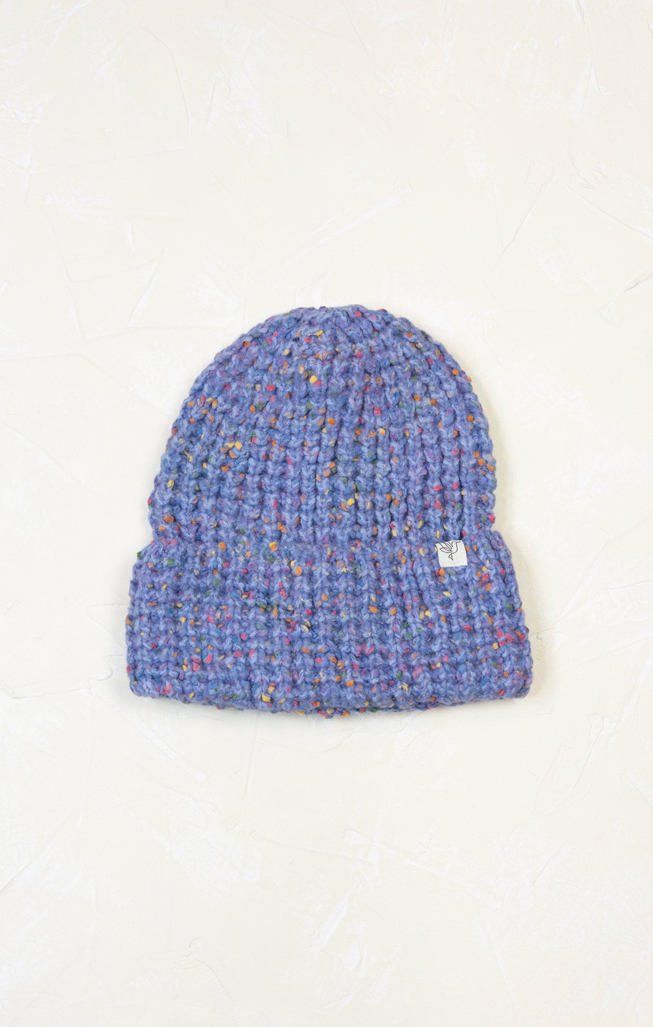 Blue knitted beanie on a white background