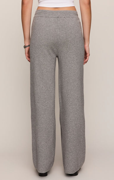 Gray sweatpants worn by a person on a plain background