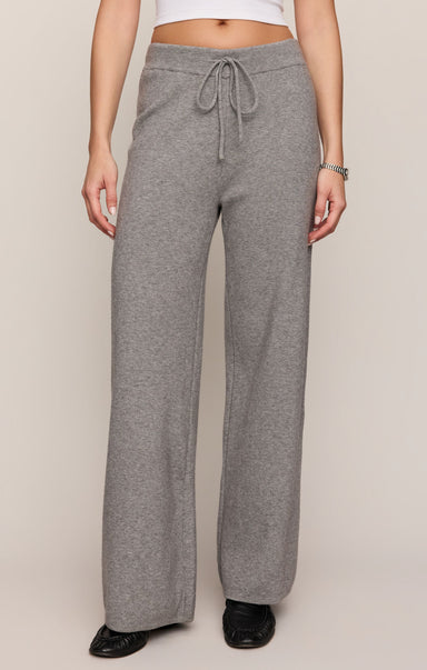 Person wearing gray sweatpants on a plain background