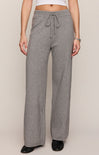 Person wearing gray sweatpants on a plain background