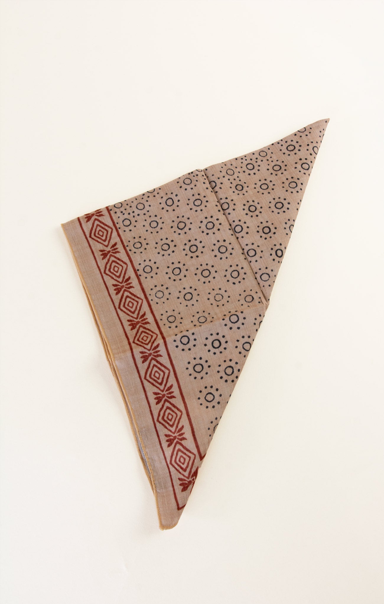 Patterned fabric triangle on a white background