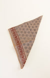 Patterned fabric triangle on a white background