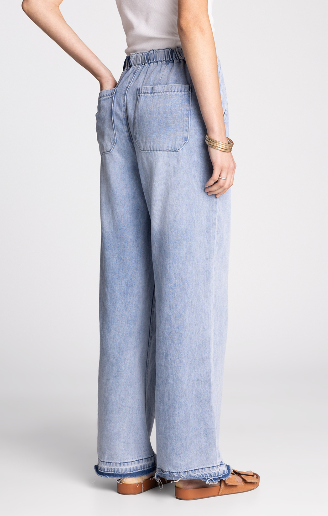 Light blue wide-leg jeans worn by a person on a white background