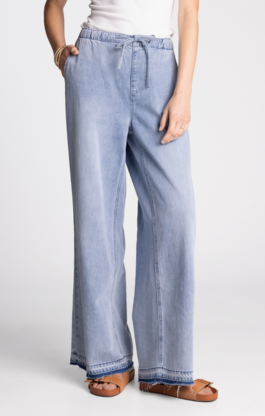 Light blue jeans worn by a person on a white background